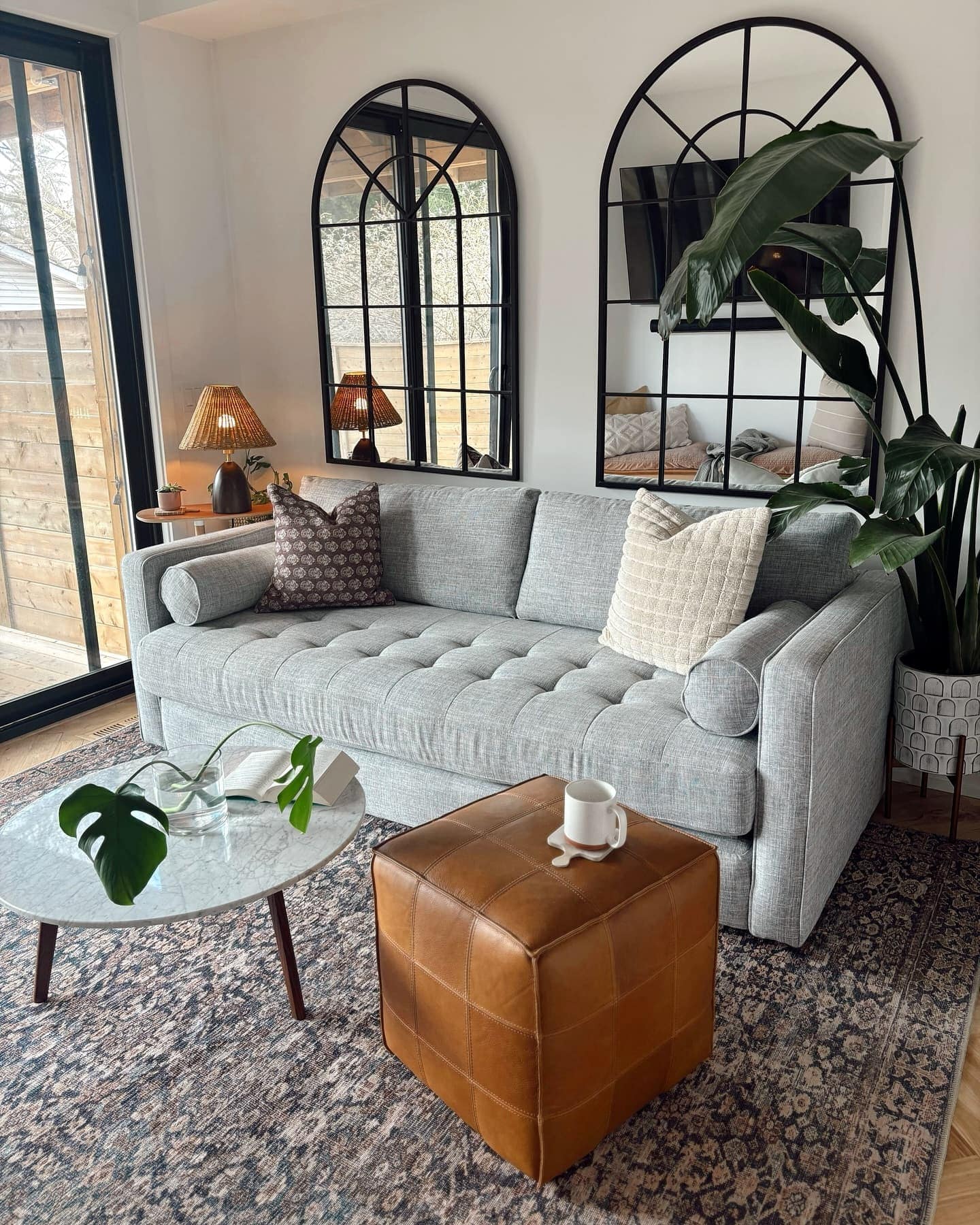 Luxury Home Decor Article Sven fabric sofa in stone gray styled with a vintage rug and modern coffee table.